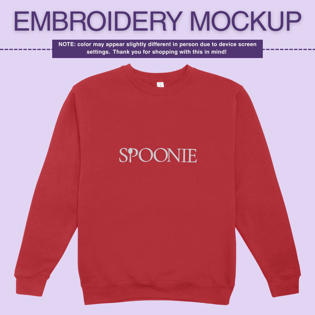 Bright red sweatshirt with 'SPOONIE' embroidery design on a light purple background