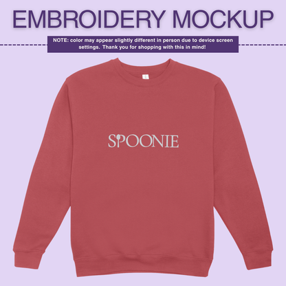 Soft red sweatshirt with 'SPOONIE' embroidery design on a light purple background