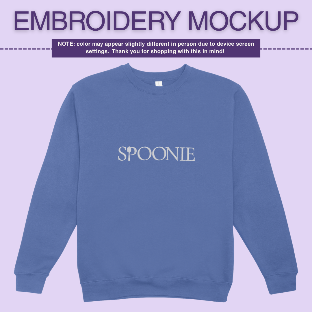 Blue sweatshirt with 'SPOONIE' embroidery design on a light purple background