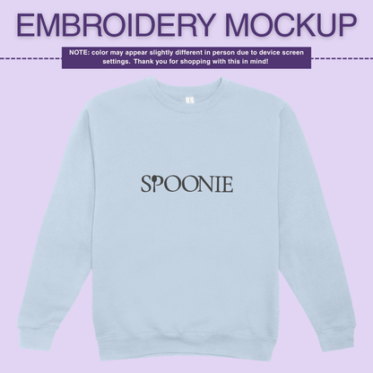 Light blue sweatshirt with 'SPOONIE' embroidery design on a pink background