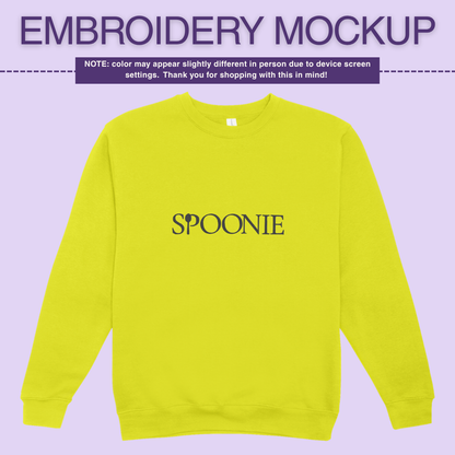 Flourescent yellow sweatshirt with 'SPOONIE' embroidery design on a purple background